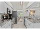 Modern kitchen with stainless steel appliances, granite countertops, and white cabinetry at 11927 Steppingstone Blvd, Tampa, FL 33635
