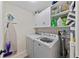 Functional laundry room includes modern washer and dryer with plenty of storage at 11927 Steppingstone Blvd, Tampa, FL 33635