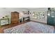 Bright living room showcases hardwood floors, a large rug, and lots of natural light at 11927 Steppingstone Blvd, Tampa, FL 33635