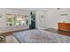 Inviting living room featuring hardwood floors, a colorful rug, and ample natural light at 11927 Steppingstone Blvd, Tampa, FL 33635