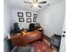 Home office with natural light, wood desk, ceiling fan and professional décor at 11927 Steppingstone Blvd, Tampa, FL 33635