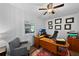 Home office with natural light, wood desk, ceiling fan and professional décor at 11927 Steppingstone Blvd, Tampa, FL 33635