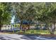 Community playground with swings, slides, and climbing structures surrounded by trees at 11927 Steppingstone Blvd, Tampa, FL 33635