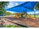 Bright, covered community playground featuring multiple slides, swings, and climbing structures at 11927 Steppingstone Blvd, Tampa, FL 33635