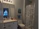 Well-lit bathroom with a sink and vanity, shower and tub, and a decorative shower curtain at 1216 S Missouri Ave # 223, Clearwater, FL 33756