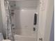 Bright bathroom features a shower-tub combination with white tile and a stylish shower curtain at 1216 S Missouri Ave # 223, Clearwater, FL 33756