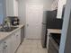 Well-lit kitchen featuring modern appliances, ample countertop space, white cabinets, and tile flooring at 1216 S Missouri Ave # 223, Clearwater, FL 33756