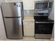 Kitchen featuring stainless steel appliances and an electric range with matching white cabinets at 1216 S Missouri Ave # 223, Clearwater, FL 33756