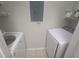Laundry room featuring a white washer and dryer with white wire shelving for extra storage at 1216 S Missouri Ave # 223, Clearwater, FL 33756