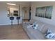 Open concept living area with a view of the kitchen, hardwood floors, and a comfortable sofa at 1216 S Missouri Ave # 223, Clearwater, FL 33756