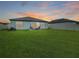 Spacious backyard featuring a lush lawn and a cozy outdoor seating area at 12170 Gothic Rd, Spring Hill, FL 34610