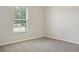 Neutral bedroom with large window letting in great natural light and comfortable carpet at 12170 Gothic Rd, Spring Hill, FL 34610
