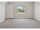 Bright bedroom with a view and neutral carpeting at 12170 Gothic Rd, Spring Hill, FL 34610