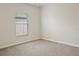 A bright, empty bedroom showcasing neutral paint and a window with blinds at 12170 Gothic Rd, Spring Hill, FL 34610