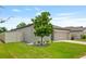 Charming single-story home featuring a well-manicured lawn, a two-car garage and a tree in the front yard at 12170 Gothic Rd, Spring Hill, FL 34610