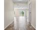 Inviting hallway with wood-look tile flooring leading to a bright living space at 12170 Gothic Rd, Spring Hill, FL 34610