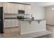 Well-lit kitchen featuring stainless steel appliances, granite counters, and white cabinets at 12170 Gothic Rd, Spring Hill, FL 34610