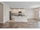 Well-lit kitchen with stainless steel appliances, a center island, and white cabinetry at 12170 Gothic Rd, Spring Hill, FL 34610