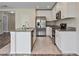 Open kitchen with stainless steel appliances, granite countertops, and white cabinetry at 12170 Gothic Rd, Spring Hill, FL 34610