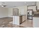 Open kitchen featuring stainless steel appliances, granite counters, and white cabinets at 12170 Gothic Rd, Spring Hill, FL 34610