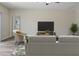 Cozy living room featuring modern furniture, stylish decor, and neutral color palette at 12170 Gothic Rd, Spring Hill, FL 34610