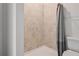 Bright shower features neutral-toned tiled walls and a sleek shower curtain at 12170 Gothic Rd, Spring Hill, FL 34610