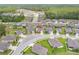 Aerial view of a community showcasing houses with well-maintained lawns and tree-lined streets at 12653 Palapa Loop, Spring Hill, FL 34610