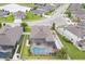 Aerial view of home with pool and screened in patio at 12653 Palapa Loop, Spring Hill, FL 34610