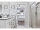 Bathroom with double vanity sinks, granite countertops and a glass door shower with sleek black fixtures at 12653 Palapa Loop, Spring Hill, FL 34610