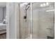 Close up of a modern glass door shower with sleek black fixtures and neutral tile surround at 12653 Palapa Loop, Spring Hill, FL 34610