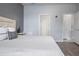 Well lit bedroom offering wood floors, neutral paint, and multiple doors to additional spaces at 12653 Palapa Loop, Spring Hill, FL 34610