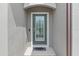 A charming front door with decorative glass detail, offering a warm welcome to guests at 12653 Palapa Loop, Spring Hill, FL 34610