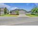 Charming single-story home with well-maintained landscaping, a paved driveway, and a two-car garage at 12653 Palapa Loop, Spring Hill, FL 34610