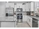 Bright kitchen featuring stainless steel appliances, granite countertops, and white cabinetry at 12653 Palapa Loop, Spring Hill, FL 34610
