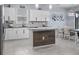 Well-lit kitchen featuring white cabinets, granite countertops and modern stainless steel appliances at 12653 Palapa Loop, Spring Hill, FL 34610