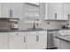 Modern kitchen features stainless steel appliances, granite countertops, and a stylish faucet at 12653 Palapa Loop, Spring Hill, FL 34610