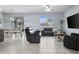 An open concept living room, with tile floors, connecting the kitchen, dining and living areas at 12653 Palapa Loop, Spring Hill, FL 34610