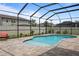 Well-maintained pool with a screened enclosure at 12653 Palapa Loop, Spring Hill, FL 34610