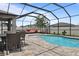 Inviting screened-in pool with outdoor dining and lounge area, great for relaxing and entertaining at 12653 Palapa Loop, Spring Hill, FL 34610