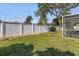 Well-maintained backyard featuring a white vinyl fence, and a screened lanai at 13000 90Th Ave, Seminole, FL 33776