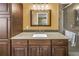 Bathroom featuring granite countertops, wood cabinets, and a walk-in shower with glass door at 13000 90Th Ave, Seminole, FL 33776