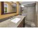 Well-lit bathroom featuring granite countertop, wood vanity, and glass-enclosed shower at 13000 90Th Ave, Seminole, FL 33776