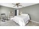 Relaxing bedroom featuring wood-look flooring, a ceiling fan, and a cozy rocking chair at 13000 90Th Ave, Seminole, FL 33776