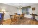 Bright dining room with hardwood floors, charming chandelier, and natural light from window at 13000 90Th Ave, Seminole, FL 33776