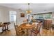 Spacious dining room with hardwood floors flowing into living room at 13000 90Th Ave, Seminole, FL 33776