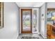 Inviting foyer with a decorative front door and tile flooring, leading into the home's interior at 13000 90Th Ave, Seminole, FL 33776