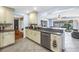 Open kitchen showcasing granite countertops and stainless steel appliances with view to backyard at 13000 90Th Ave, Seminole, FL 33776
