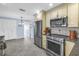 Open kitchen featuring stainless steel appliances and neutral-tone cabinets at 13000 90Th Ave, Seminole, FL 33776