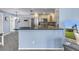 Open kitchen area with breakfast bar and gray granite countertops, with open view to yard at 13000 90Th Ave, Seminole, FL 33776