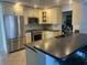This kitchen features granite countertops, stainless steel appliances, and tile flooring at 13000 90Th Ave, Seminole, FL 33776